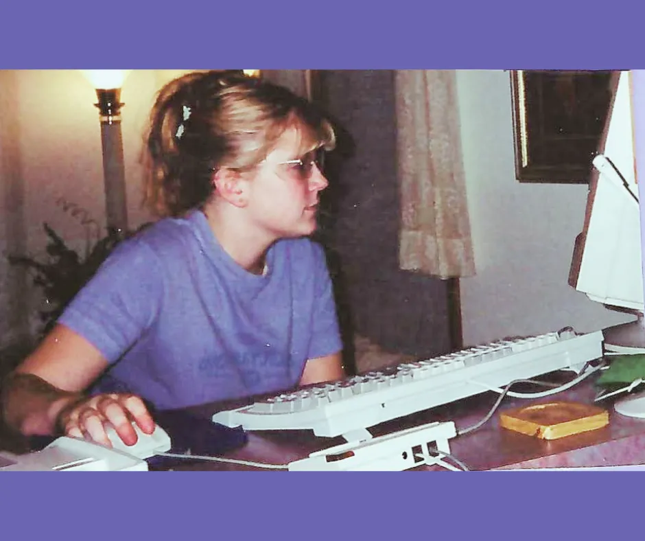 Young Randi using a desktop computer in a living room setup in 1999
