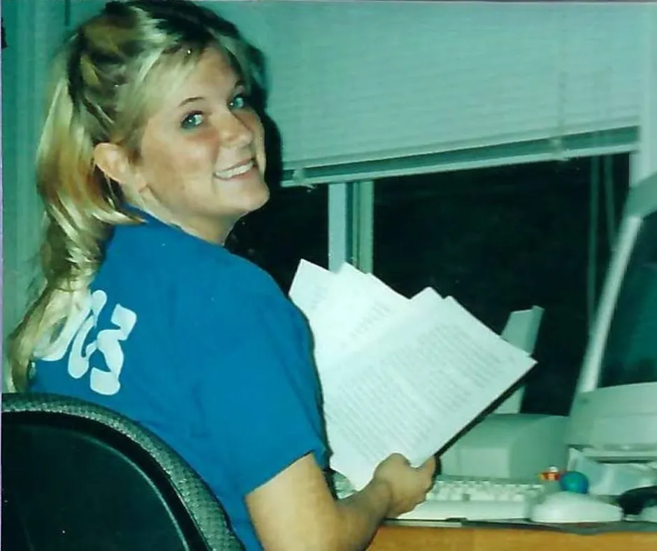 Randi at her computer with printed notes in 2003